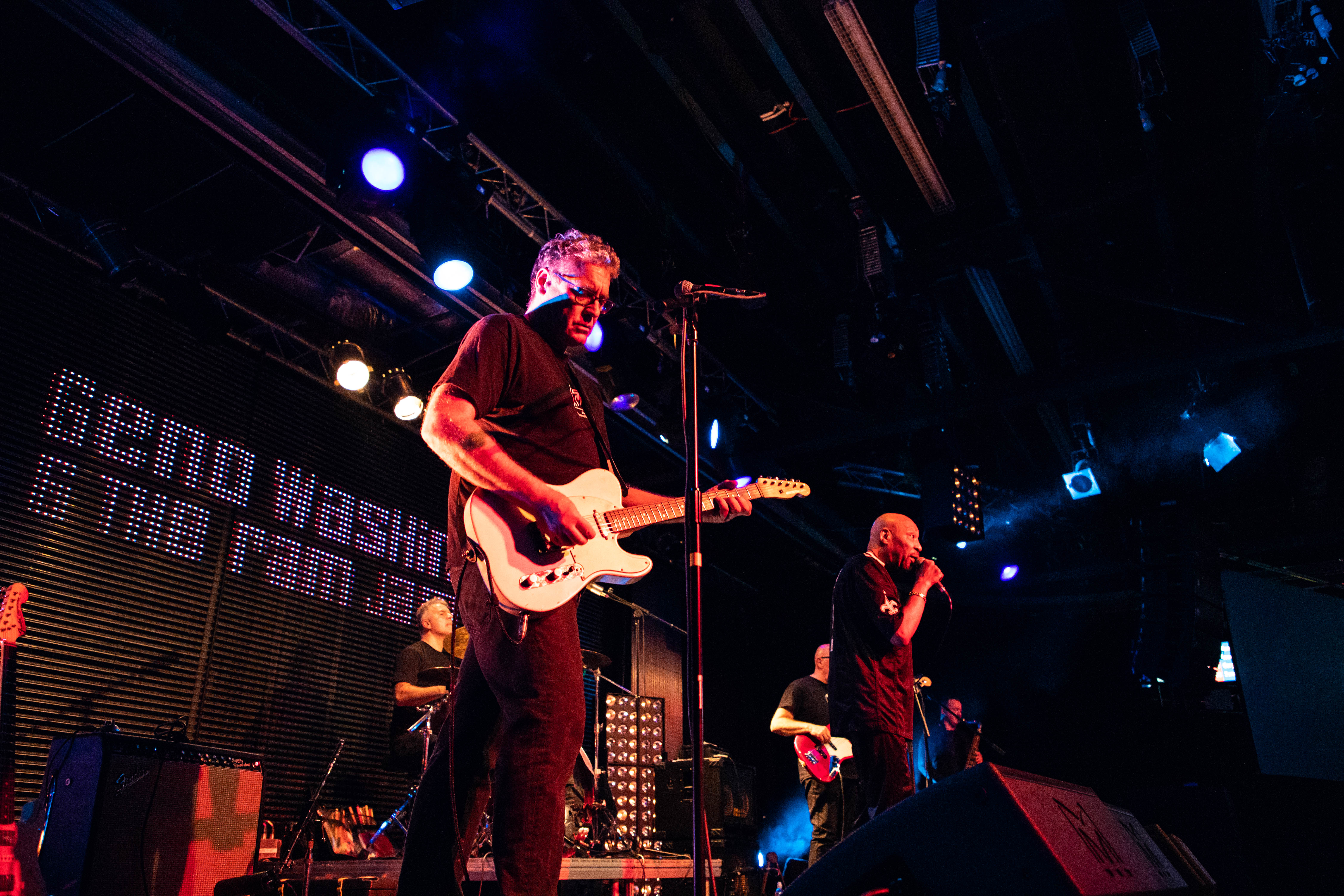 a man playing a guitar on a stage