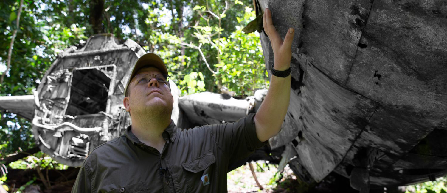 a man holding a large piece of wood