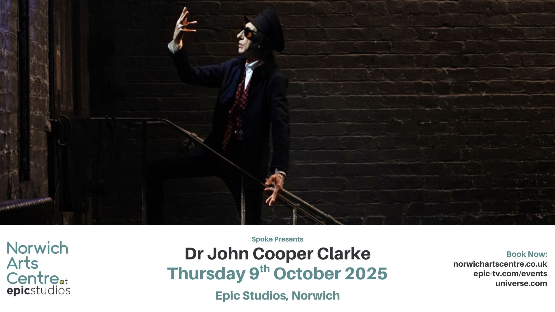 a man in a suit and tie holding a sword