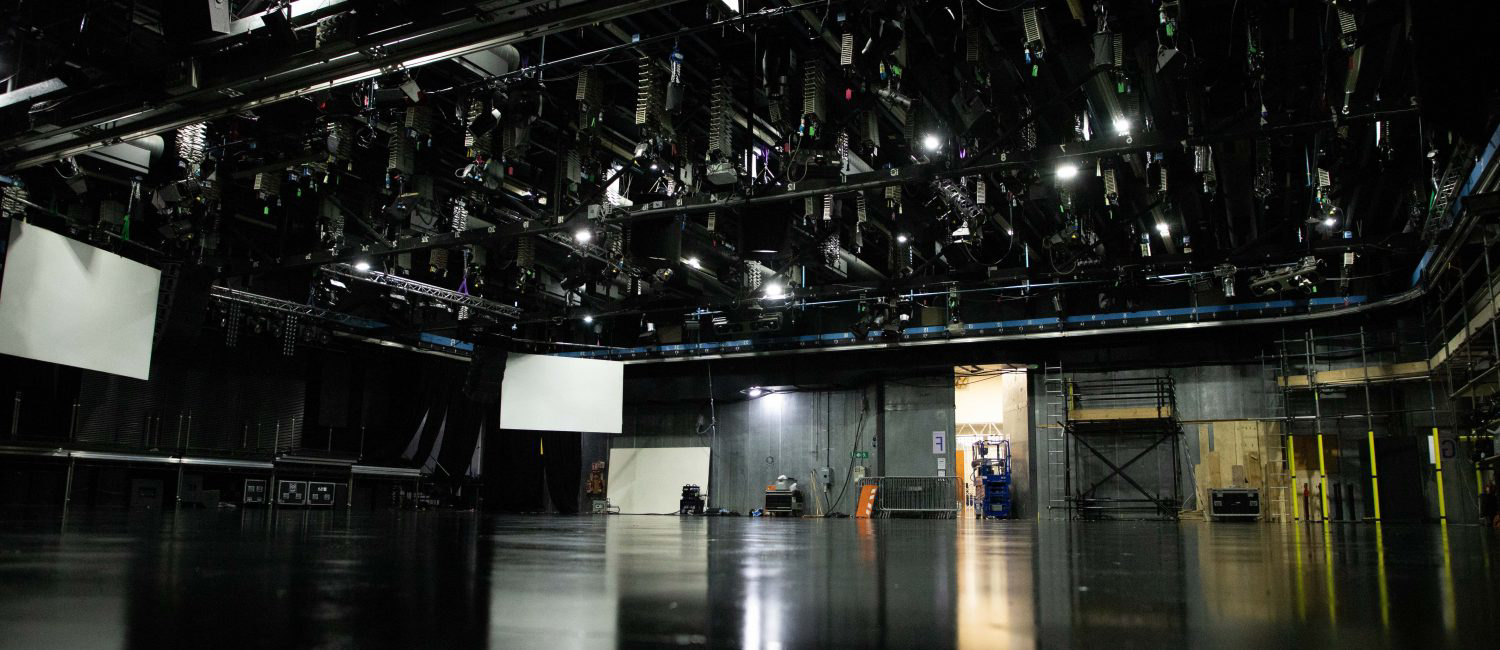a large room with a large black ceiling and white boxes on the floor