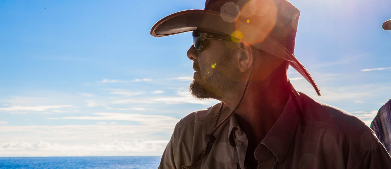 a man wearing a hat and sunglasses