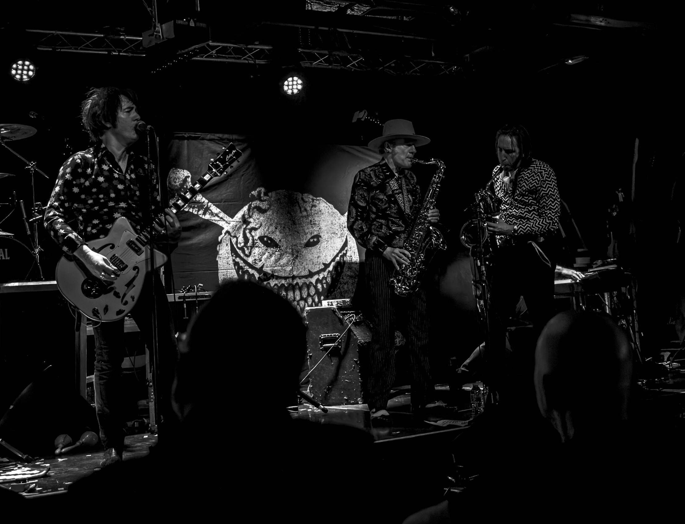 a group of men playing instruments on a stage