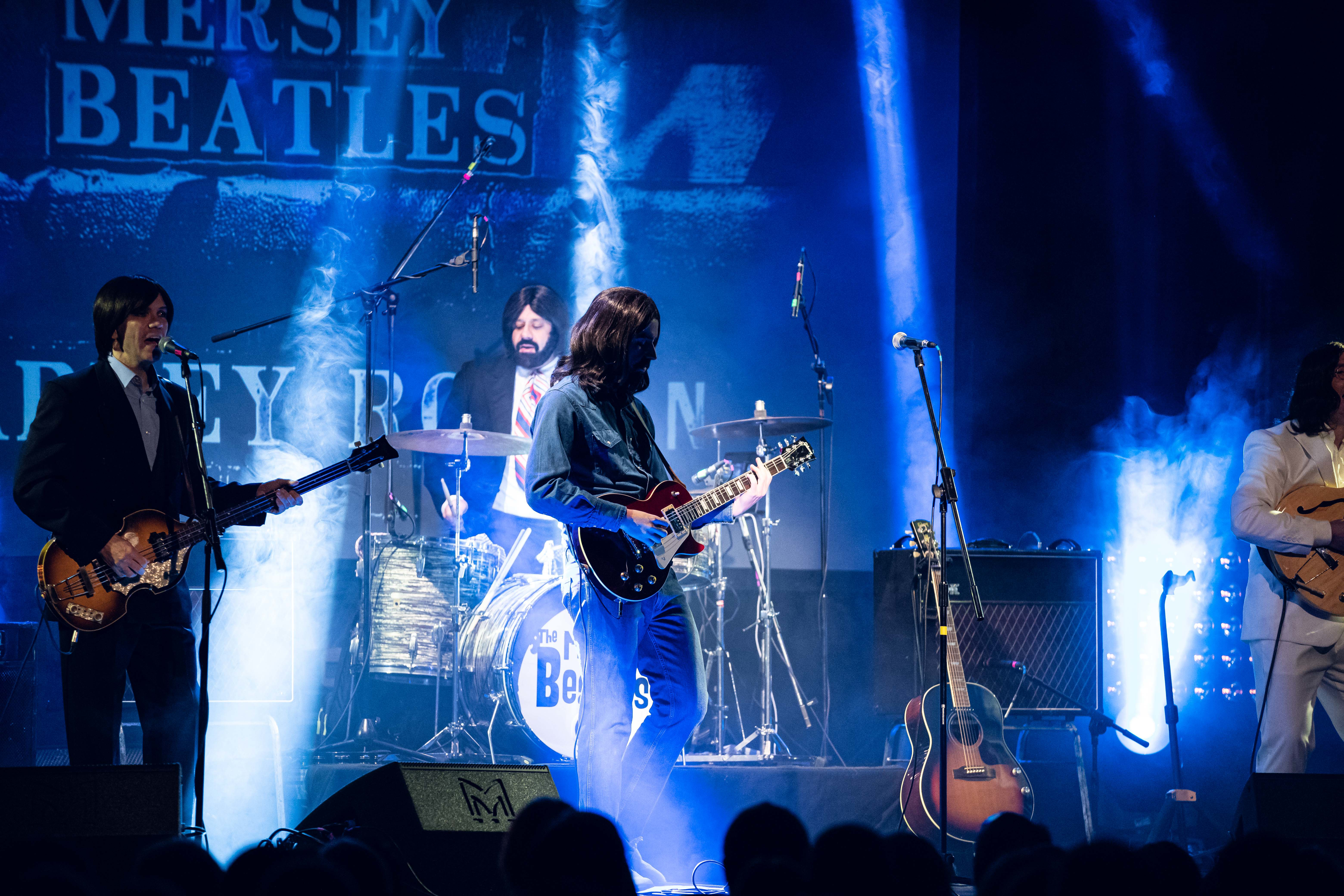 a group of people playing instruments on a stage