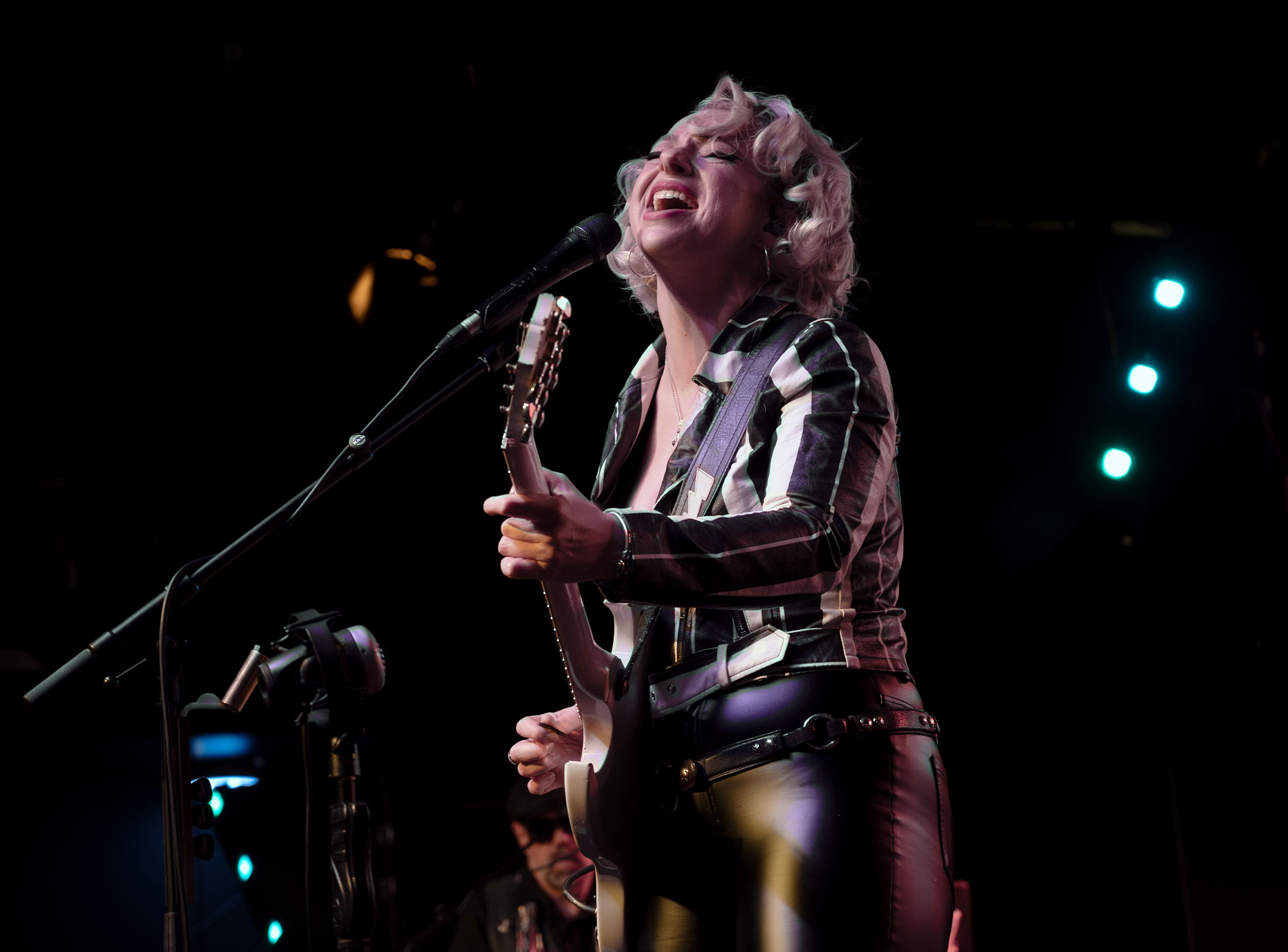 a person singing into a microphone