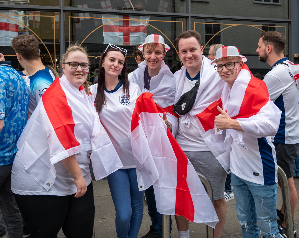 a group of people wearing white and red clothing