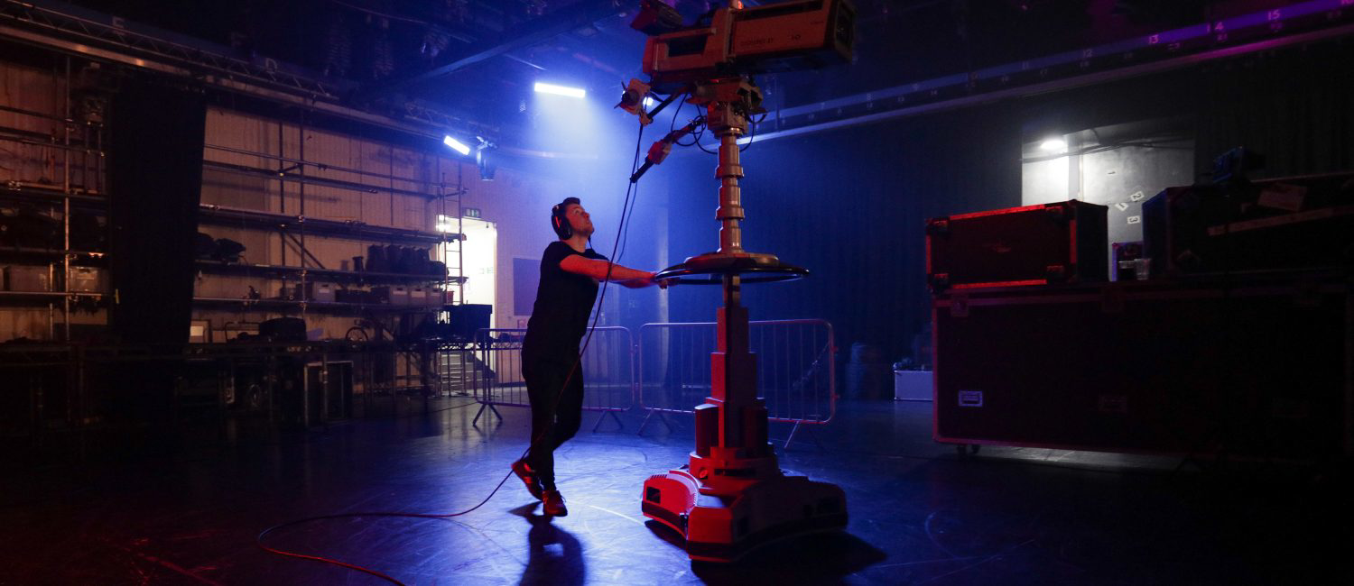 a man standing next to a machine