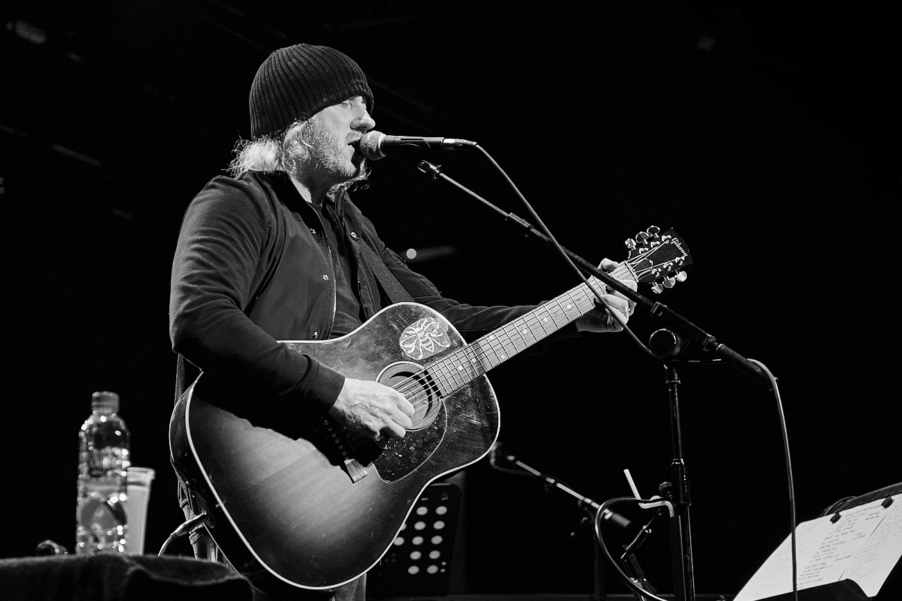 a person playing guitar on stage